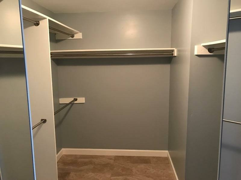 Custom walk-in closet with built-in shelving and clothing rods