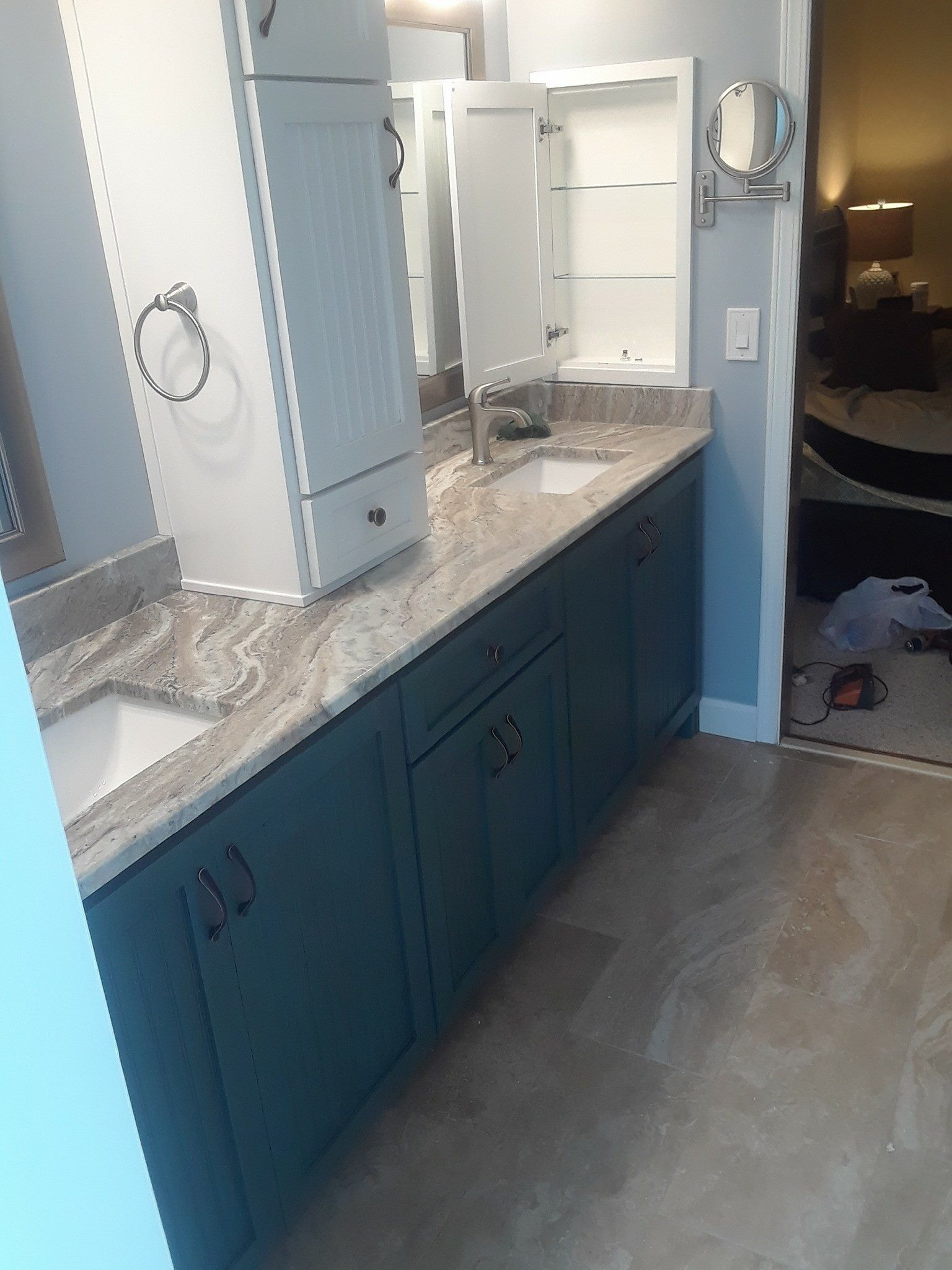 Teal double vanity with granite countertop and medicine cabinet