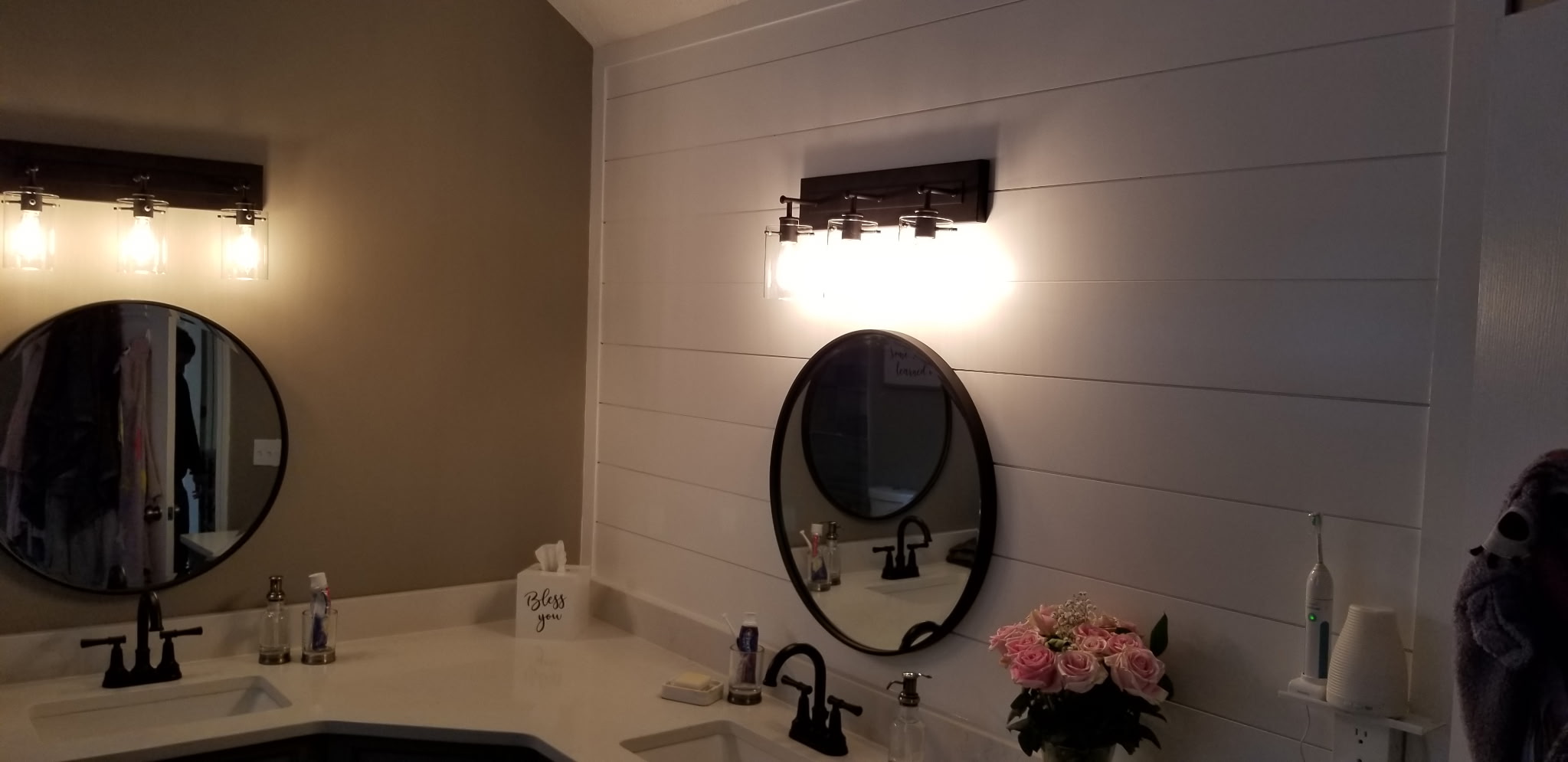 Double vanity with shiplap accent wall and round mirrors