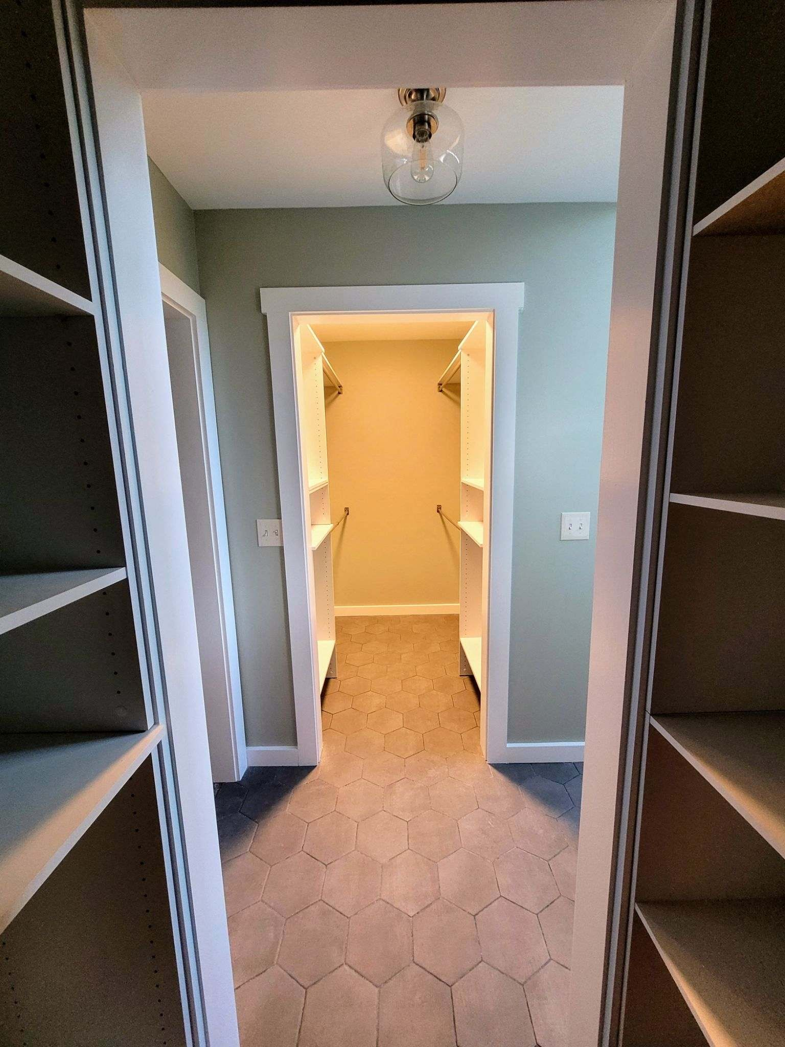His and hers walk-in closet with custom built-in shelving