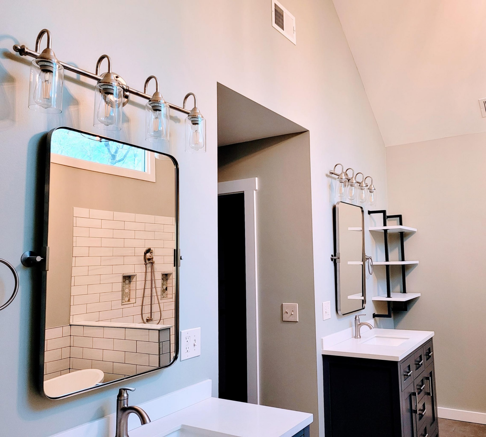 Double vanity bathroom with industrial sconce lighting