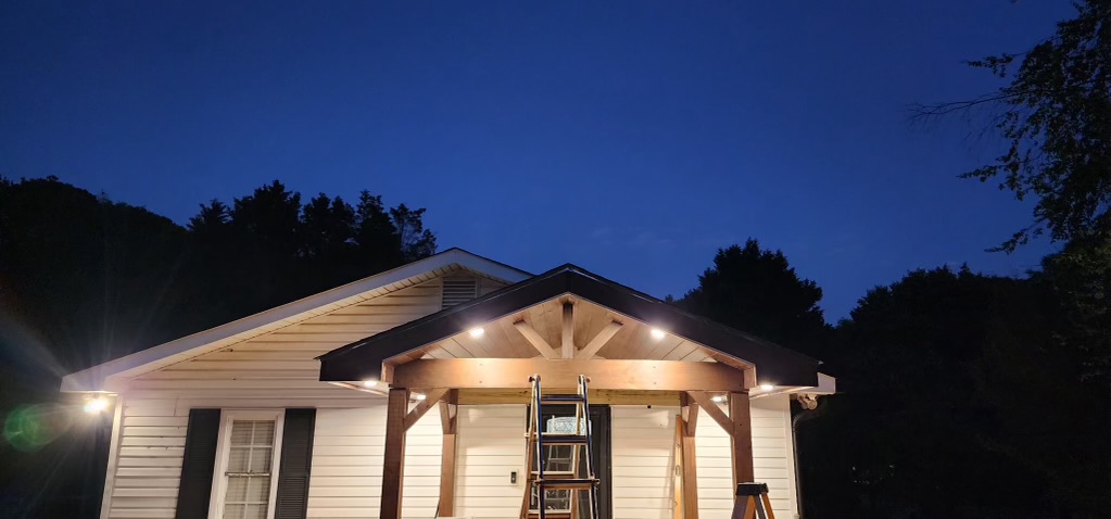 House porch addition lit up at night with recessed lighting
