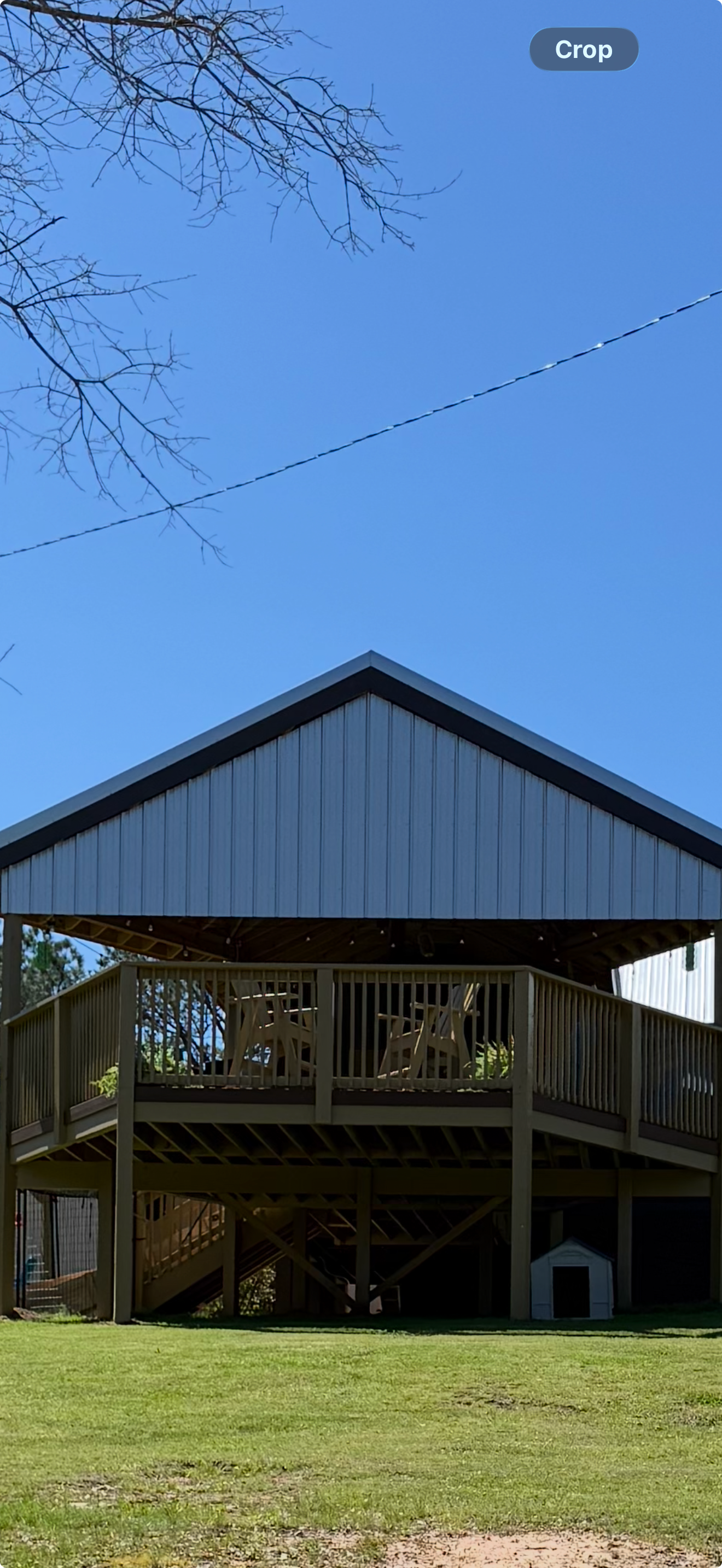 Large elevated covered pavilion deck with staircase on barn home