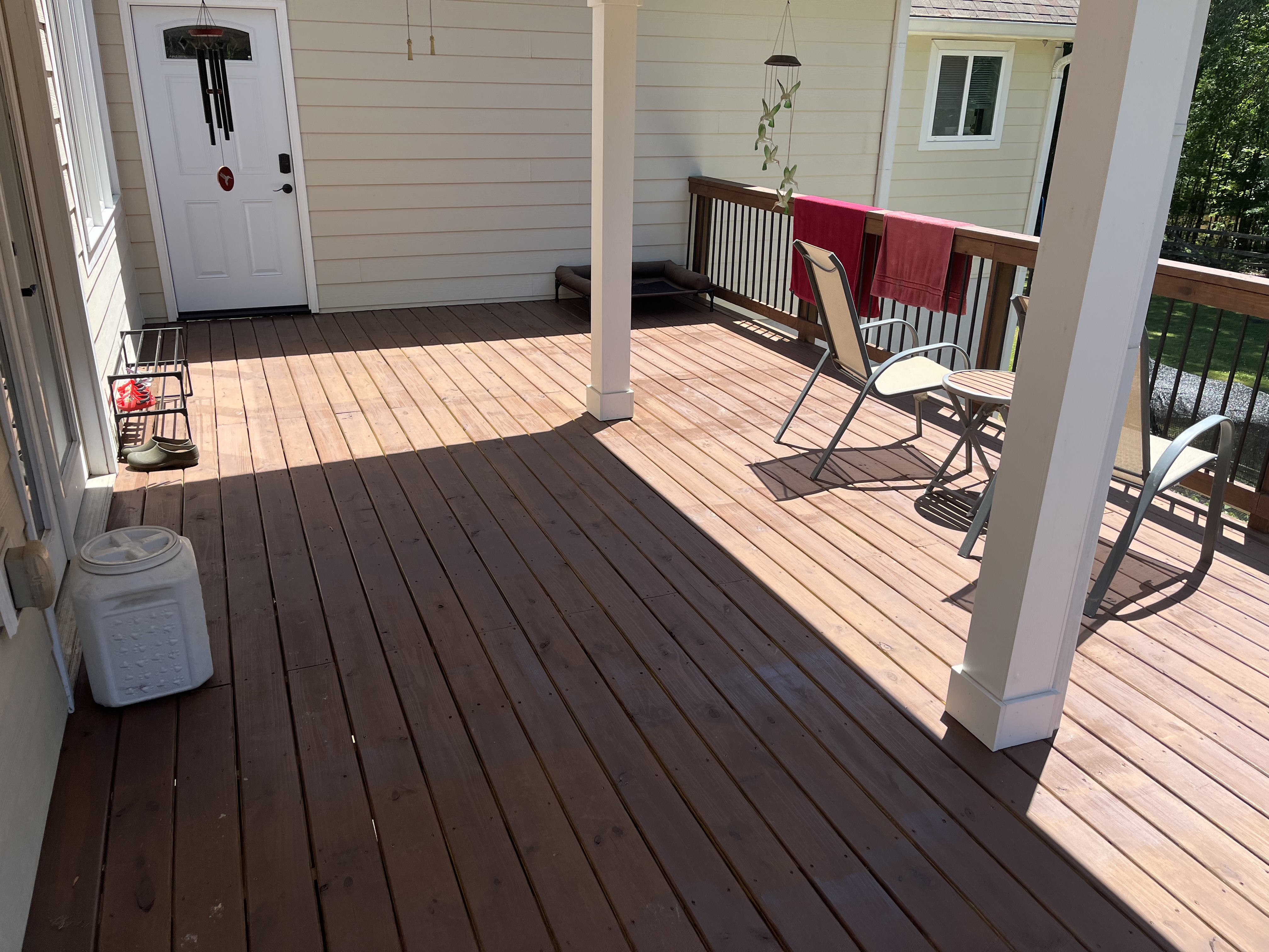 Large covered deck with white columns and outdoor seating area