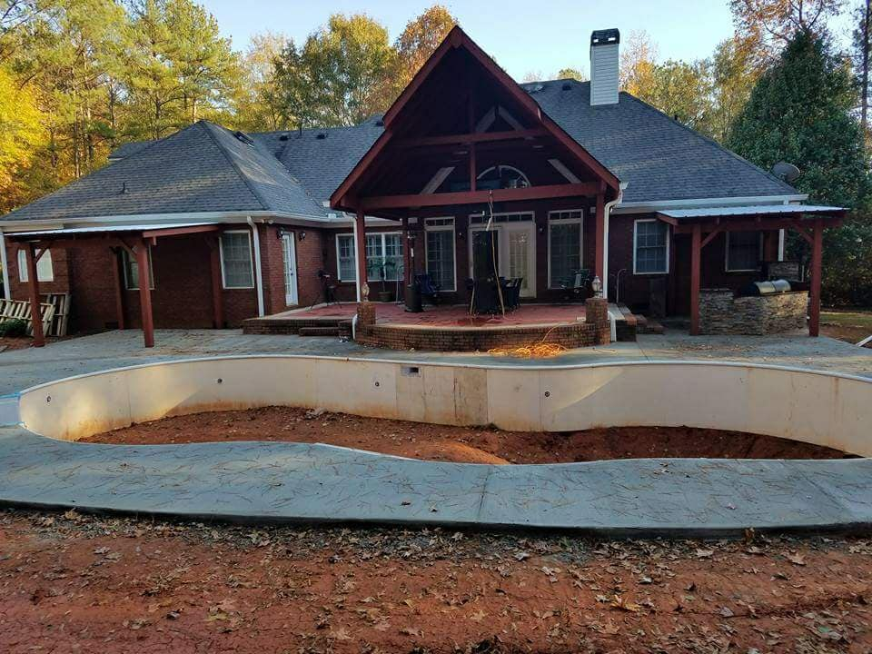 Back-of-home covered patio with outdoor kitchen and fire pit