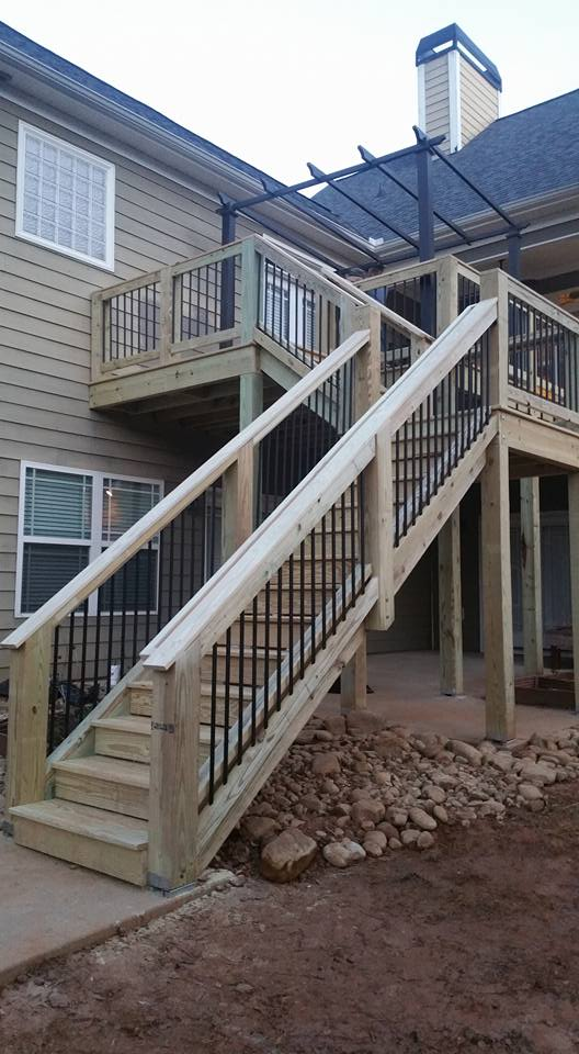 Multi-level deck staircase with metal balusters and pergola