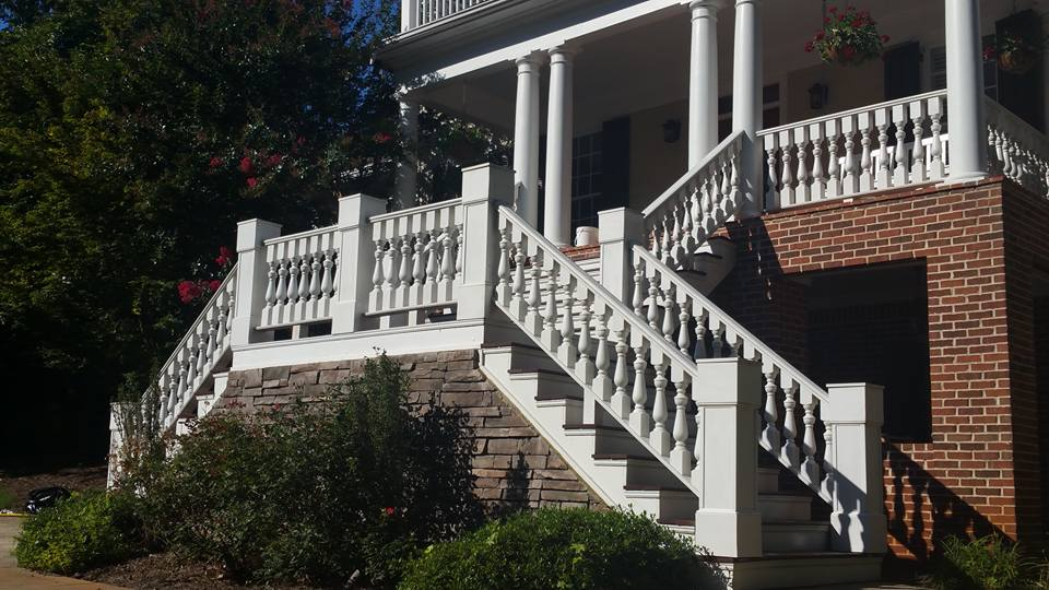 Grand front porch with white columns, balustrades and staircase