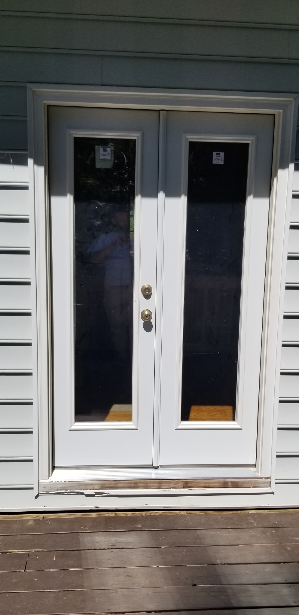 White French doors with full glass panels and gold hardware