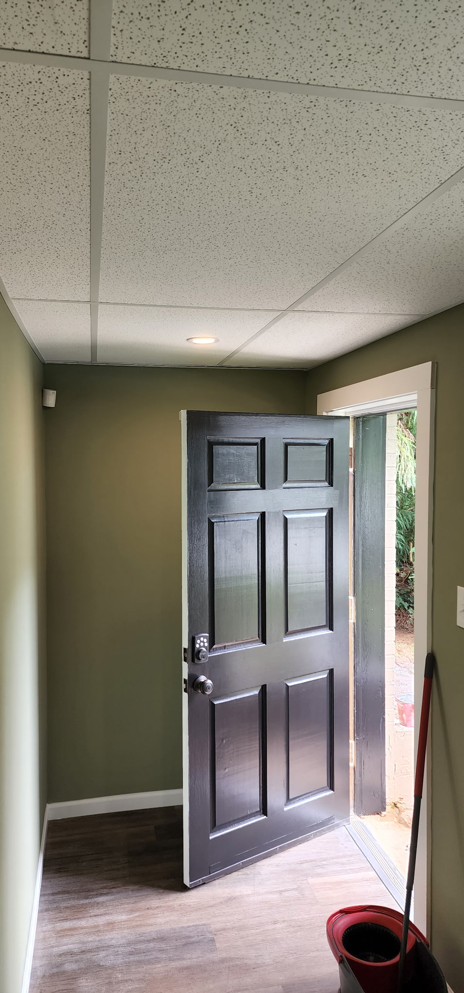 Dark interior door installation with fresh paint
