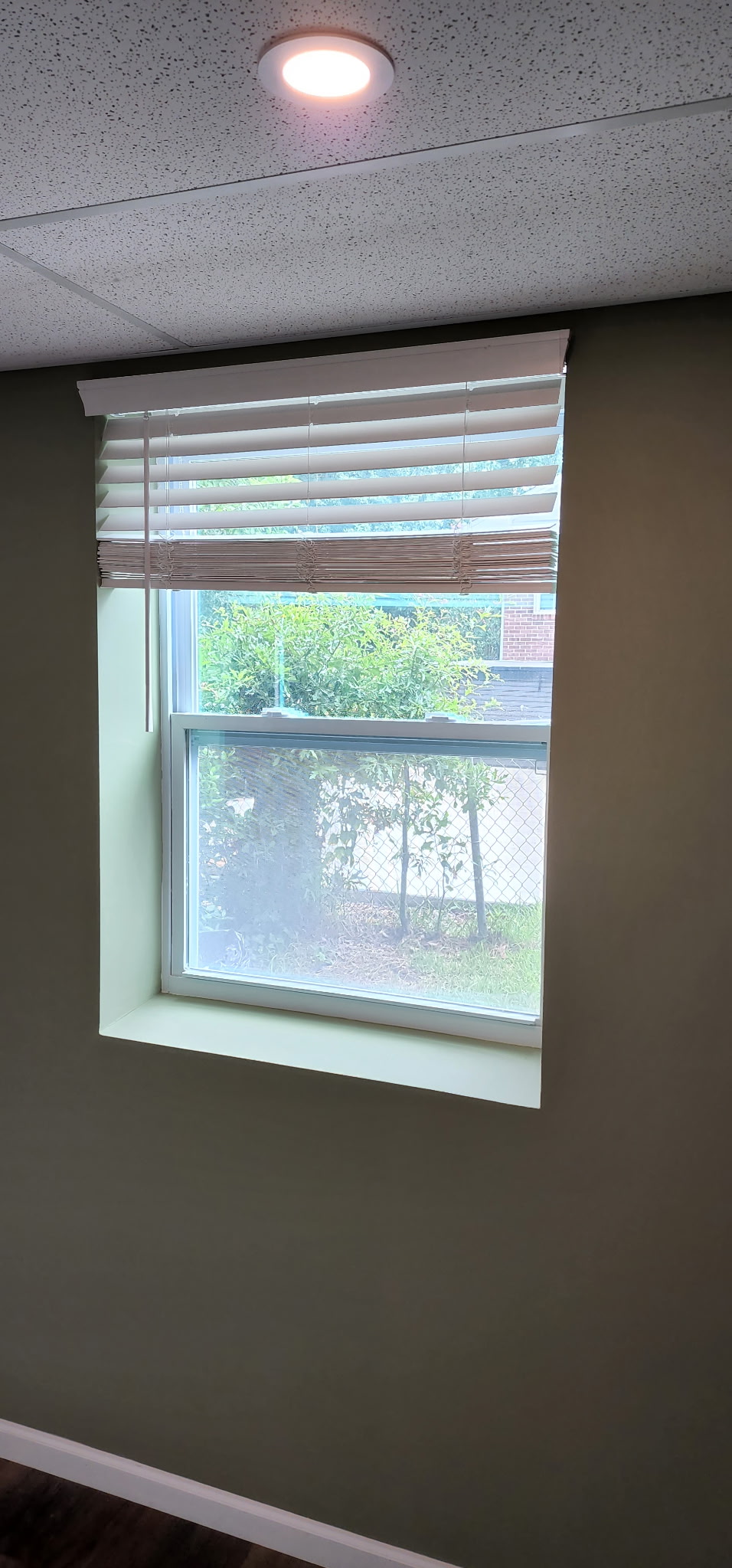 New window installation with wood blinds and fresh walls