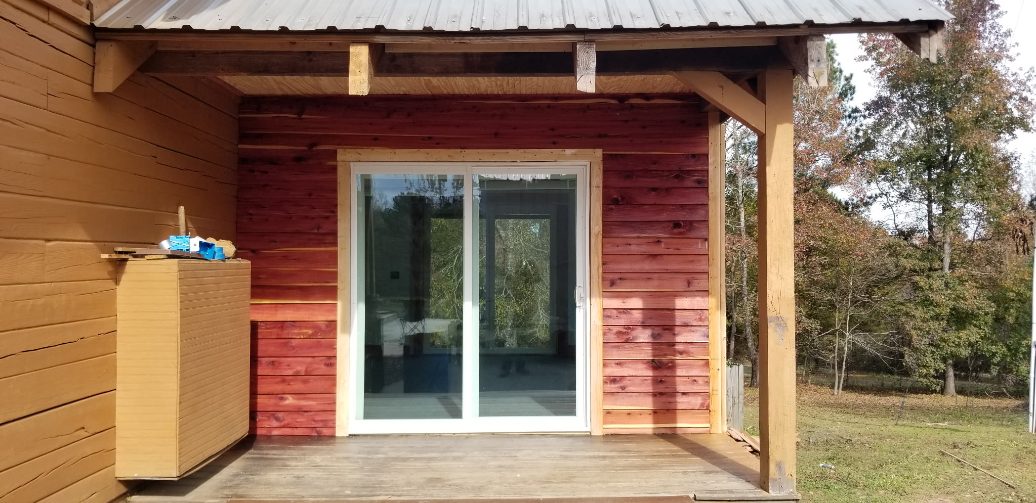 Sliding glass door installation on cedar porch addition