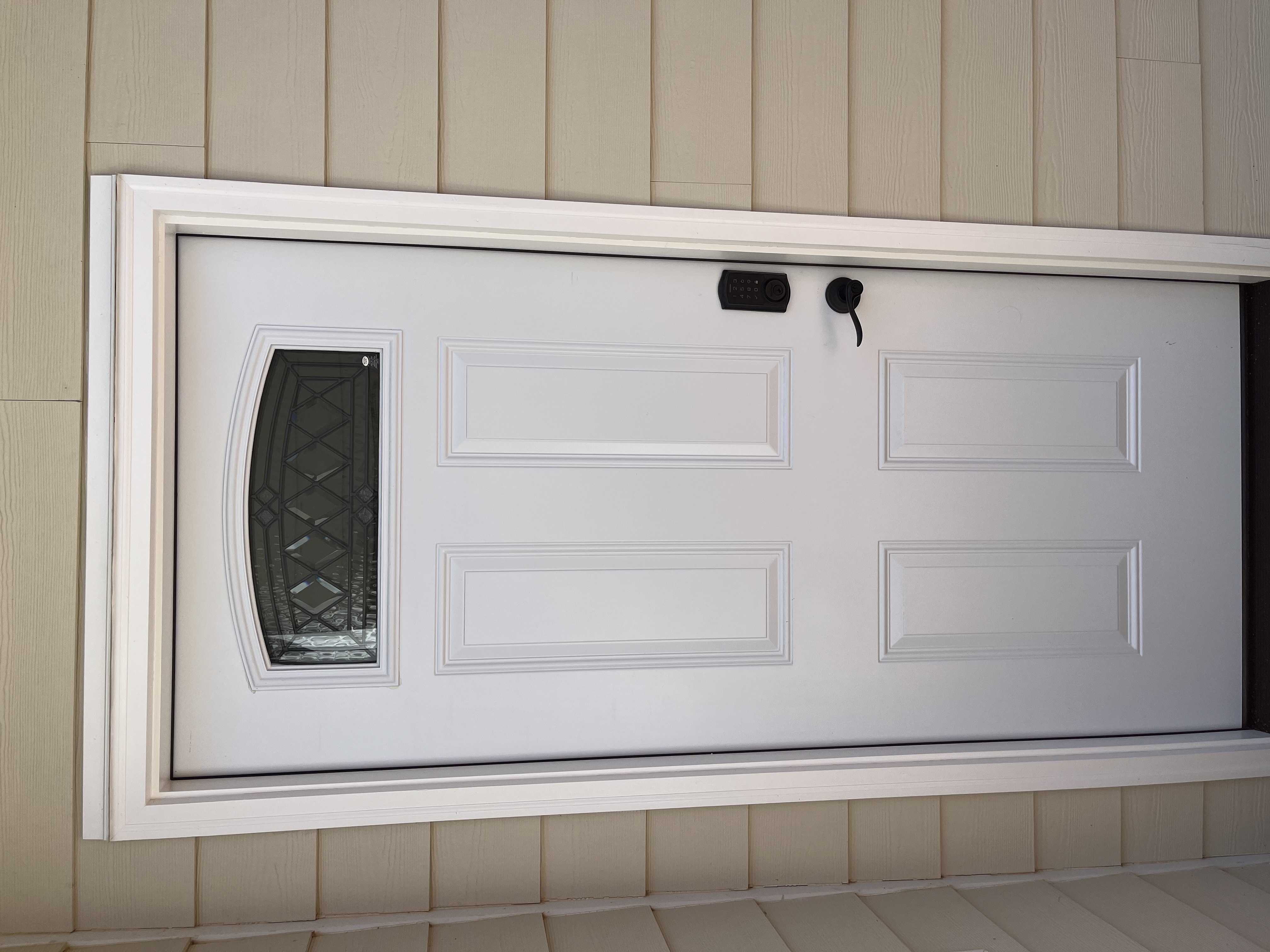 New white exterior door with arched glass insert and smart lock