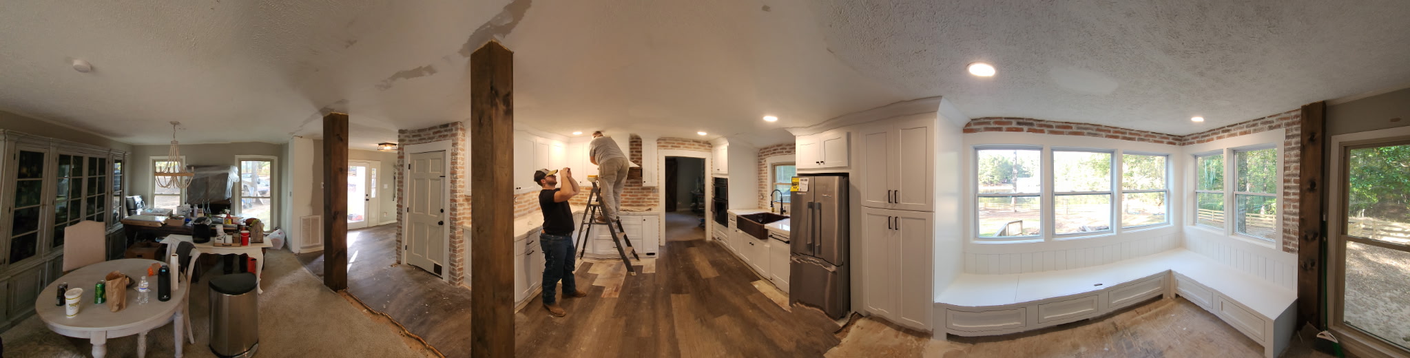 Full kitchen remodel in progress showing open concept layout and white cabinetry